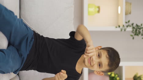 Vertical-video-of-Cheerful-boy-dancing-at-home-and-feeling-happy.